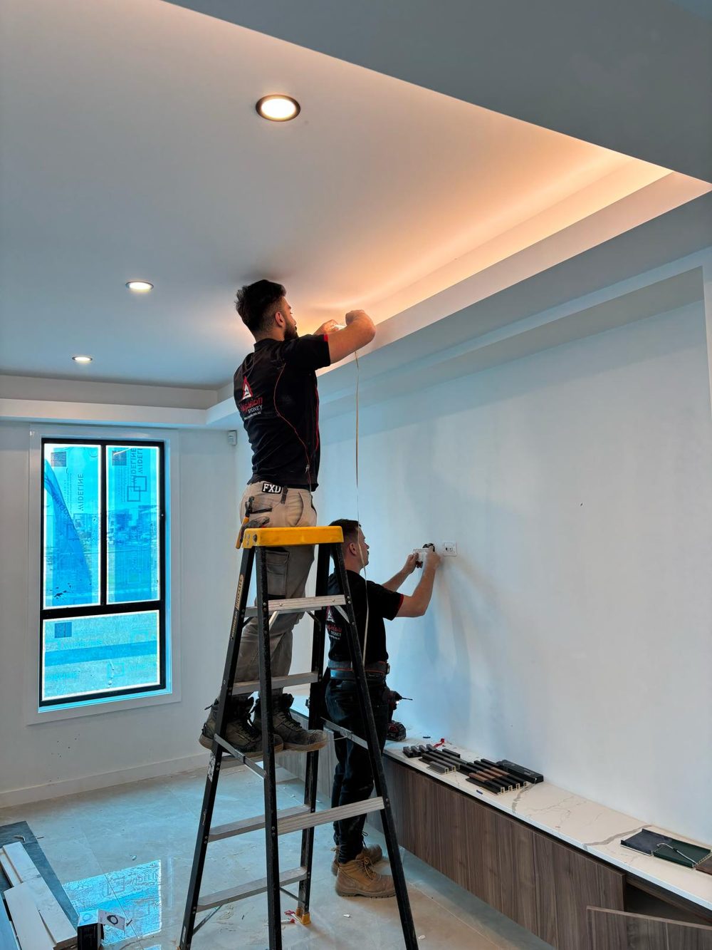 Amperion electricians installing LED strip lighting and power points in a new home